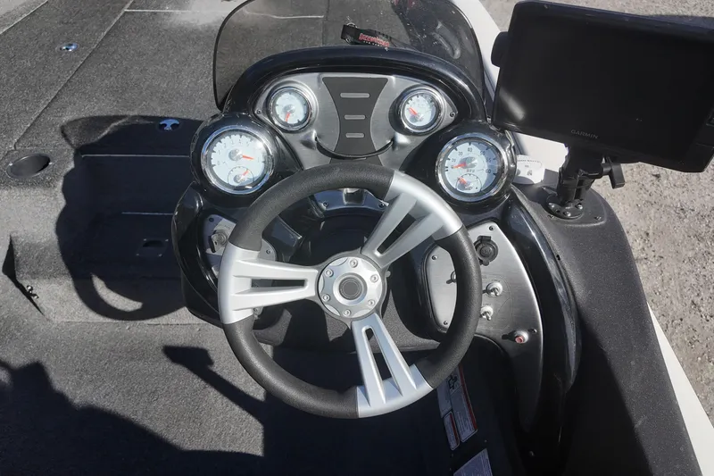 Slide: The Image of 2021 Tracker Pro Team 190 TX boat dashboard with steering wheel and gauges. - 10