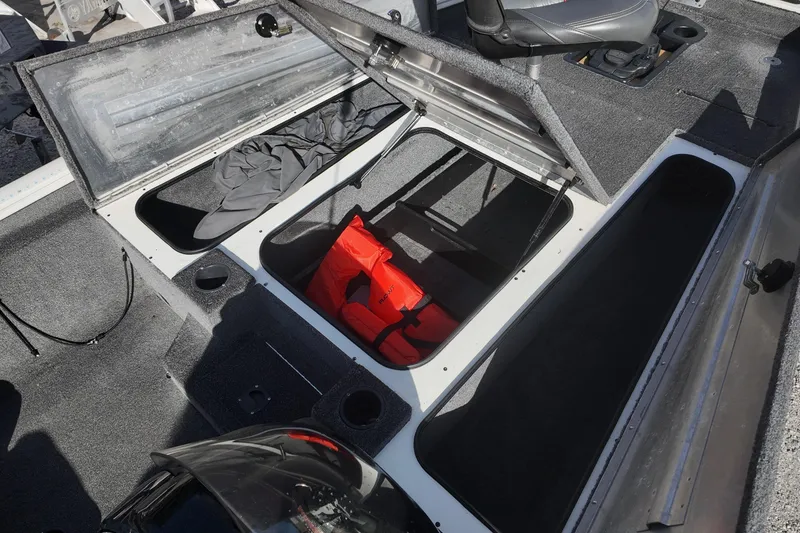 Slide: The Image of 2021 Tracker Pro Team 190 TX boat storage compartments with life jacket and gear. - 13
