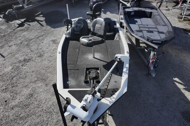 Slide: The Image of 2021 Tracker Pro Team 190 TX fishing boat on gravel lot, featuring modern design. - 14