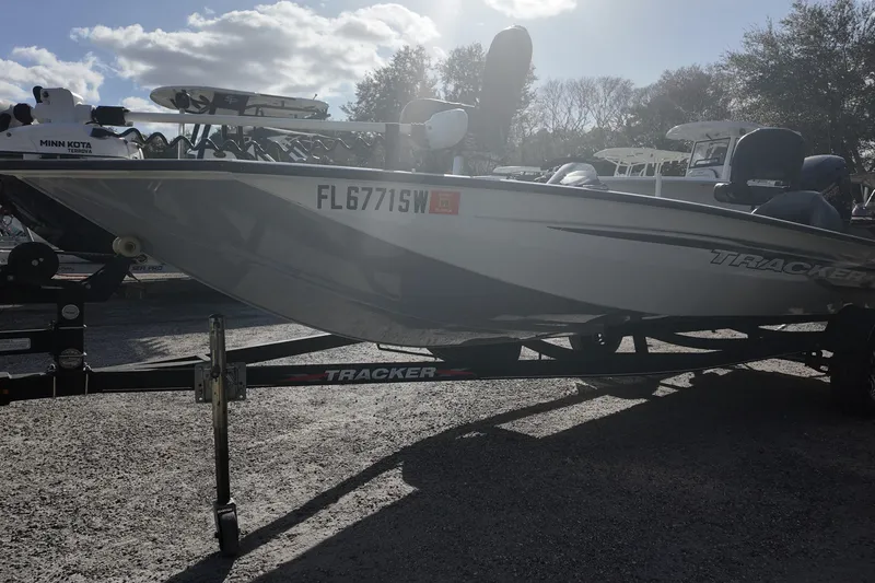 Slide: The Image of 2021 Tracker Pro Team 190 TX boat on trailer, parked outdoors under cloudy sky. - 3