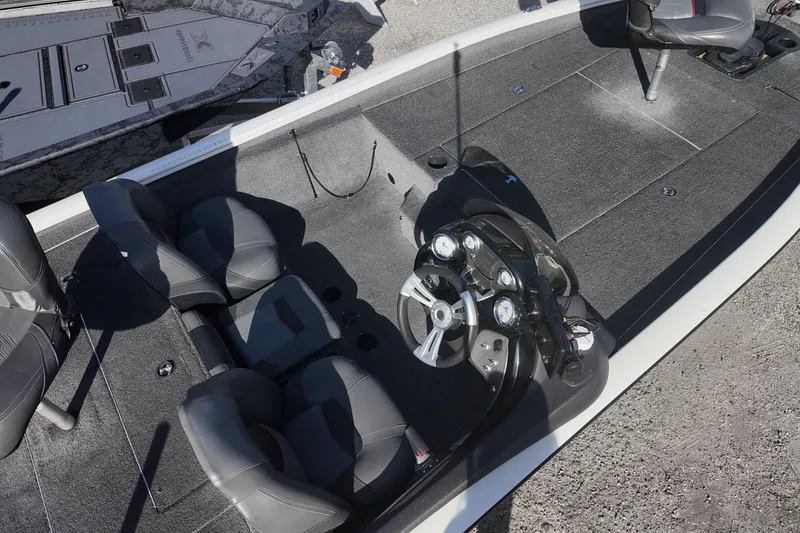 Slide: The Image of 2021 Tracker Pro Team 190 TX boat interior with steering console and seating. - 7