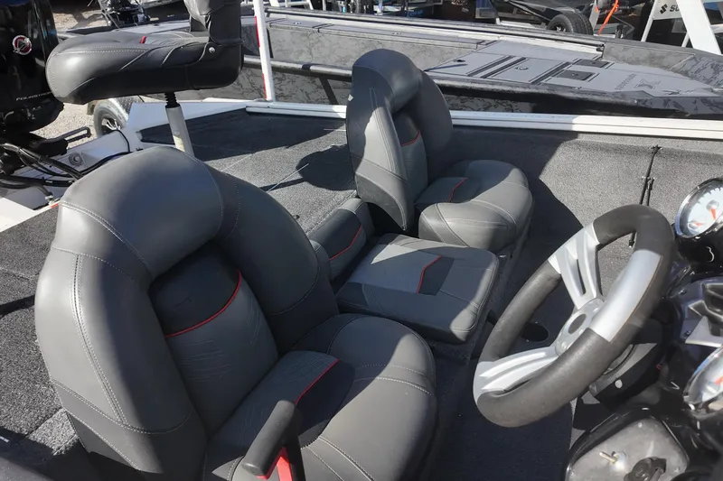 Slide: The Image of 2021 Tracker Pro Team 190 TX boat interior with gray seats and steering wheel. - 8