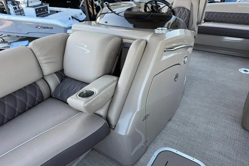 Slide: The Image of 2018 Bennington 25 QSB boat interior with plush seating and cup holder. - 15