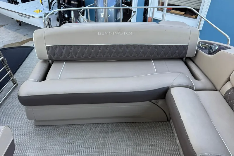 Slide: The Image of 2018 Bennington 25 QSB boat interior with cushioned seating and elegant design. - 20