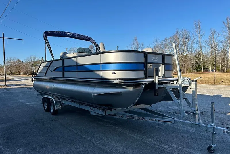 The Image of 2026 Bentley Pontoons Fish 243 Swingback on trailer, parked outdoors under clear blue sky. - 1