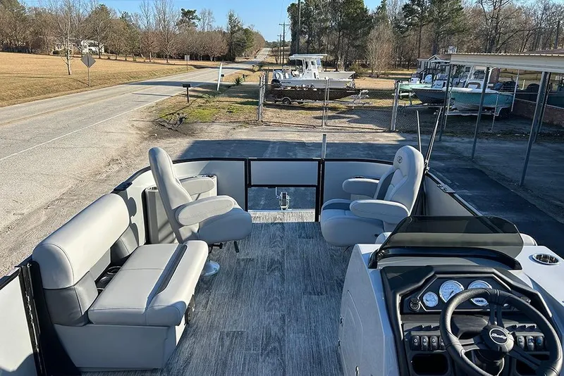 Slide: The Image of 2026 Bentley Pontoons Fish 243 Swingback with spacious seating and modern dashboard. - 11