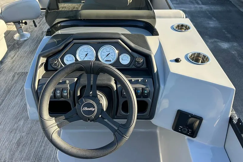 Slide: The Image of 2026 Bentley Pontoons Fish 243 Swingback dashboard with steering wheel and gauges. - 12
