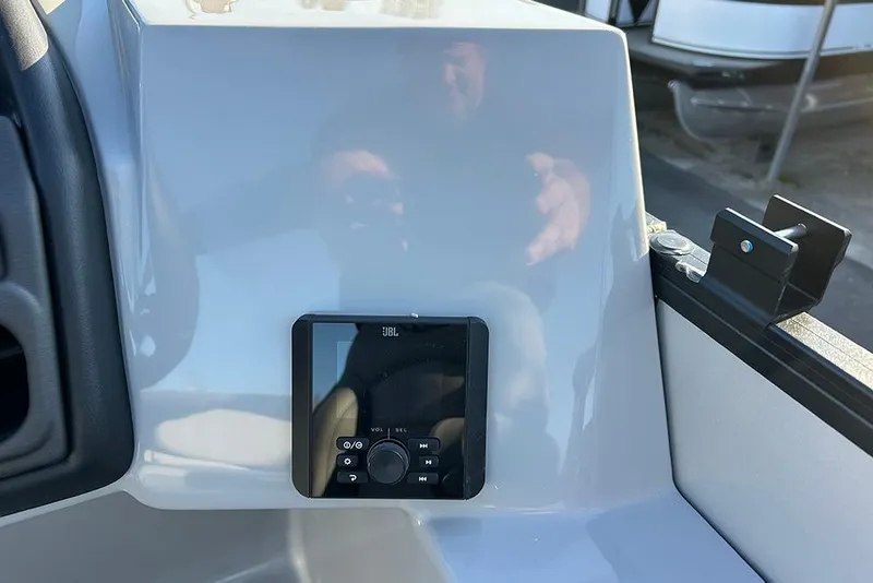 Slide: The Image of 2026 Bentley Pontoons Fish 243 Swingback dashboard with JBL audio system. - 13