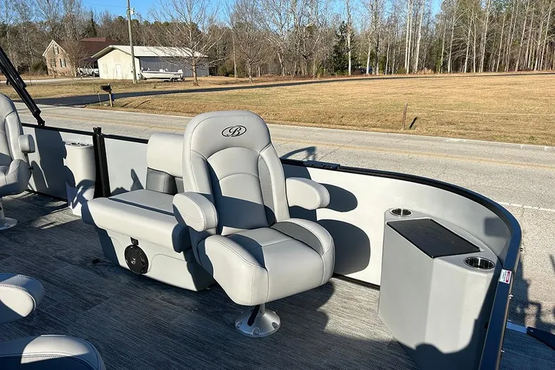 Slide: The Image of 2026 Bentley Pontoons Fish 243 Swingback interior with plush seating and console. - 19