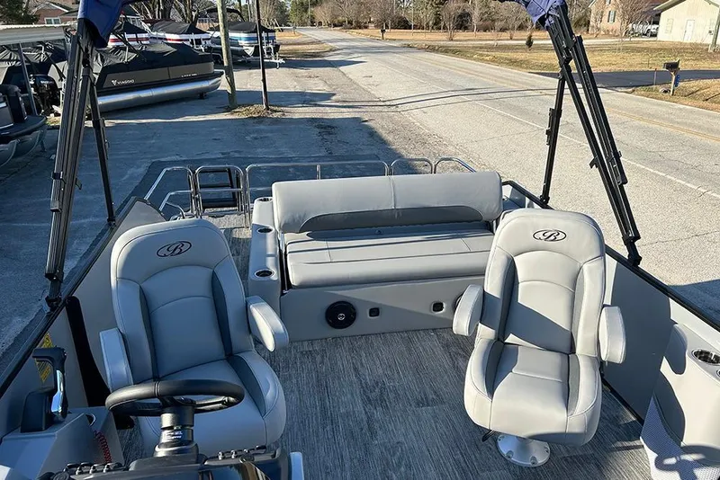 Slide: The Image of 2026 Bentley Pontoons Fish 243 Swingback interior with plush seating and steering wheel. - 24
