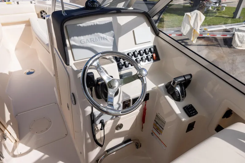 Slide: The Image of 2023 Grady-White Freedom 255 boat helm with Garmin navigation system and control panel. - 10