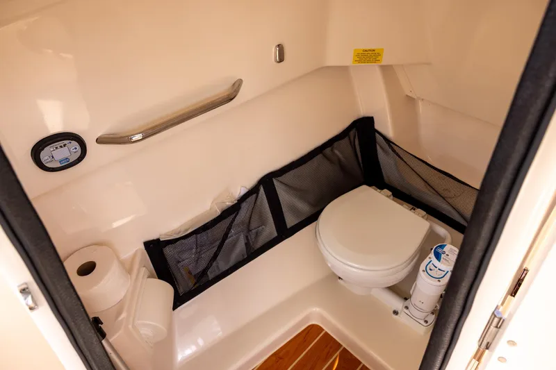 Slide: The Image of 2023 Grady-White Freedom 255 boat interior bathroom with toilet and storage. - 14