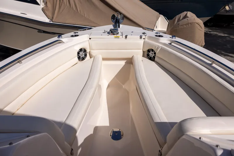 Slide: The Image of 2023 Grady-White Freedom 255 boat interior with cushioned seating and speakers. - 15