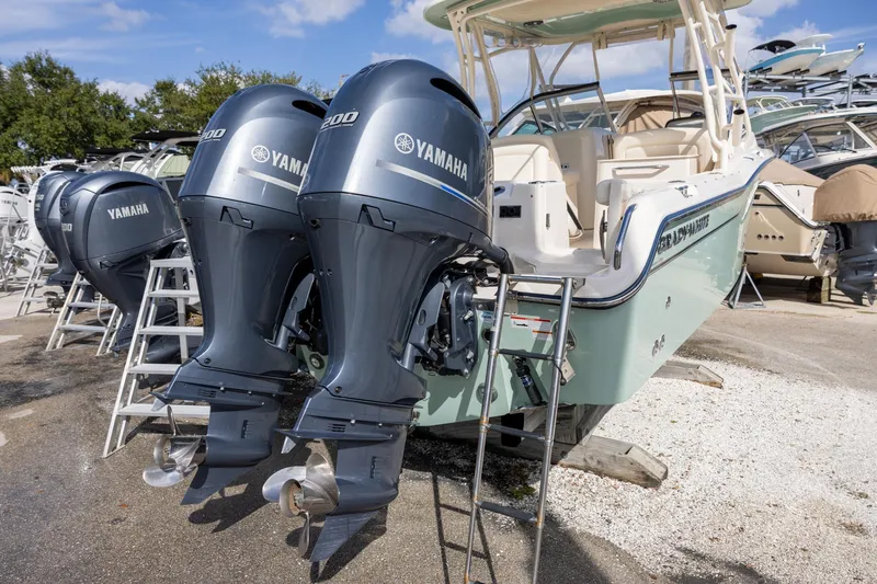 Slide: The Image of 2023 Grady-White Freedom 255 boat with dual Yamaha outboard engines displayed outdoors. - 3