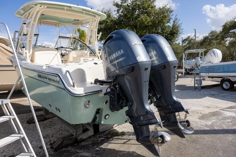 Slide: The Image of 2023 Grady-White Freedom 255 boat with dual Yamaha 200 engines, parked outdoors. - 4