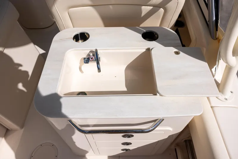 Slide: The Image of 2023 Grady-White Freedom 255 boat sink with faucet and storage. - 8