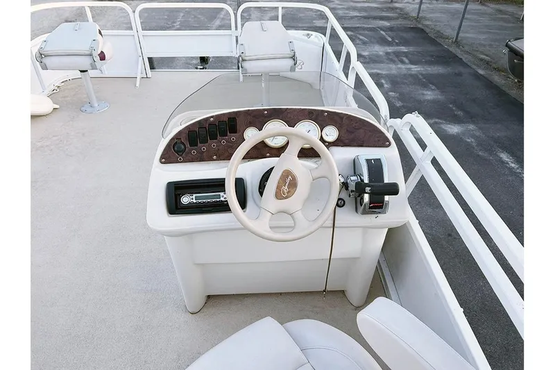 Slide: The Image of 2006 Bentley Pontoons 200 Fish boat dashboard with steering wheel and controls. - 10