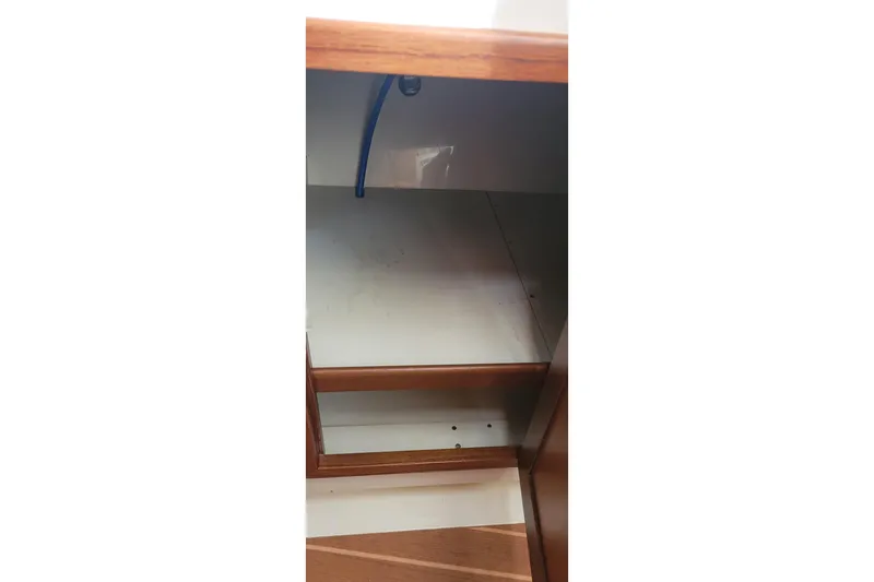 Slide: The Image of Empty wooden cabinet interior on a 2015 Fortier 30 boat. - 16