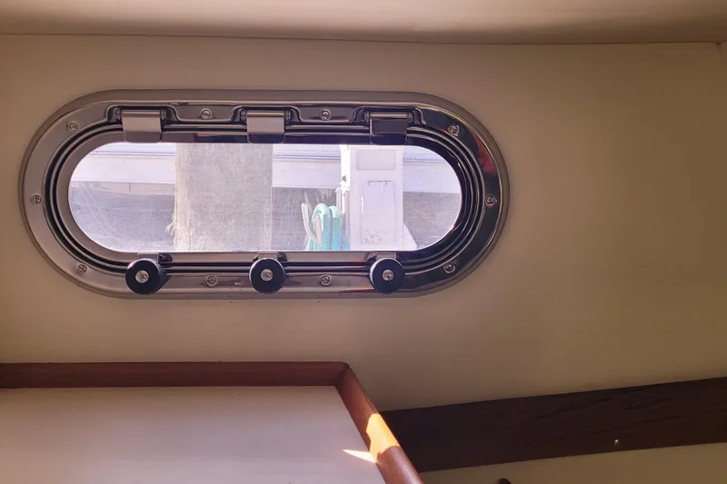 Slide: The Image of Porthole view from 2015 Fortier 30 boat interior, showcasing sleek design and natural light. - 17