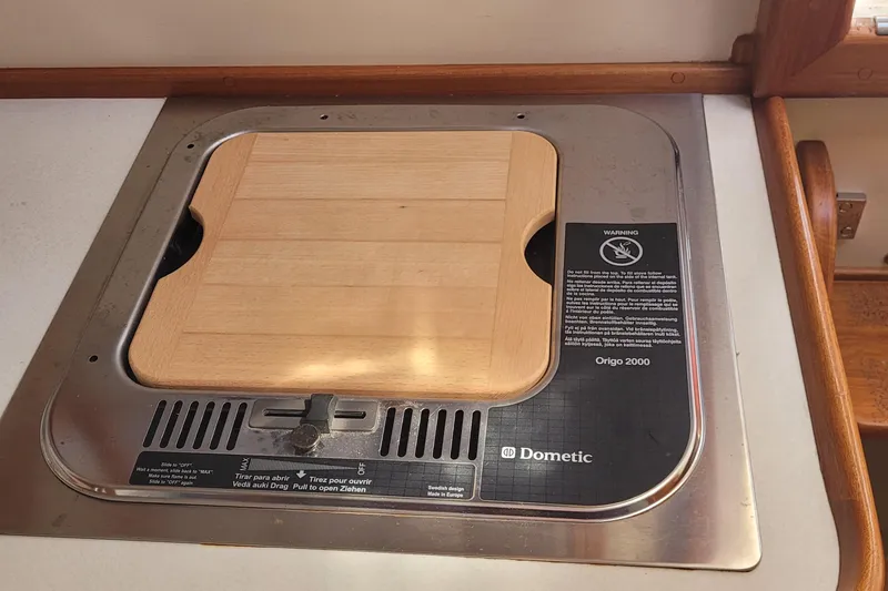 Slide: The Image of Built-in Dometic Origo 2000 stove with wooden cover on Fortier 30, 2015 model. - 20