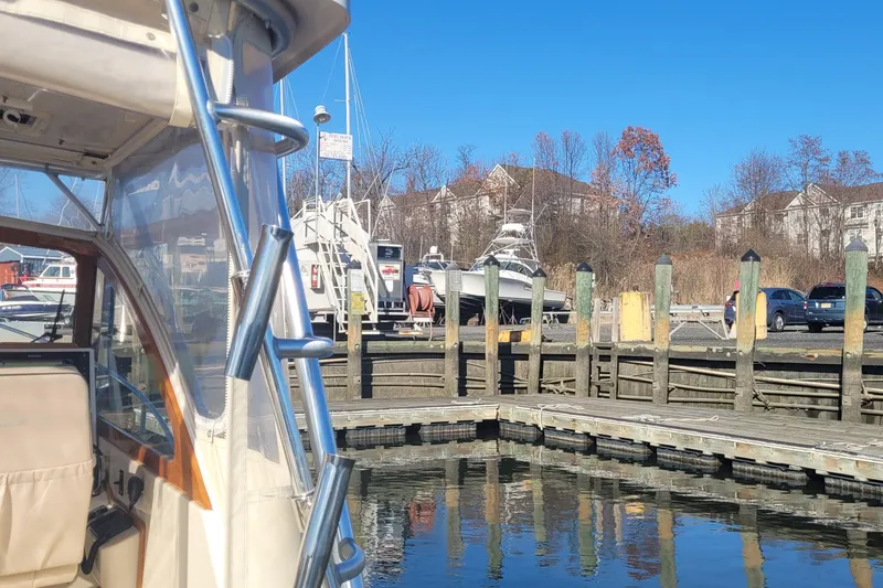 Slide: The Image of Fortier 30 boat docked at marina, clear blue sky, 2015 model. - 23