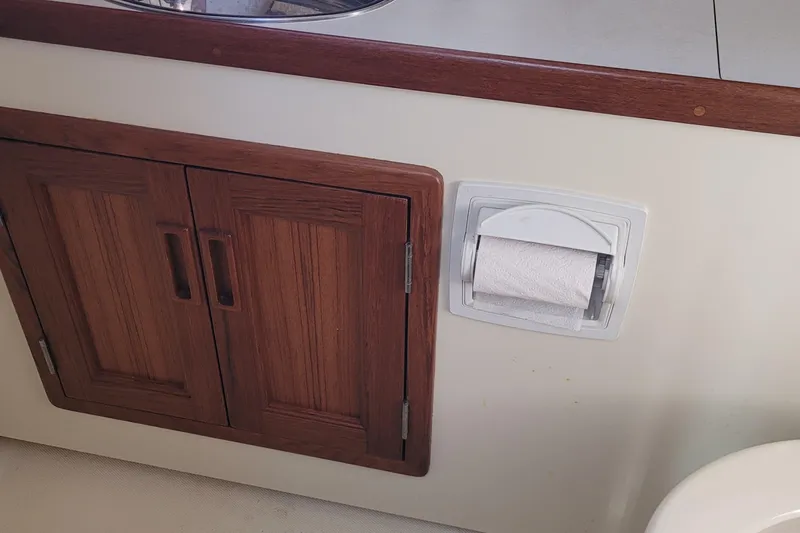 Slide: The Image of Wooden cabinet and toilet paper holder in 2015 Fortier 30 boat interior. - 26