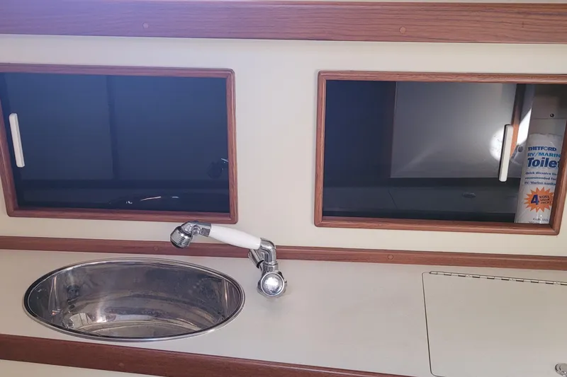Slide: The Image of Interior of 2015 Fortier 30 boat with sink and storage cabinets. - 27