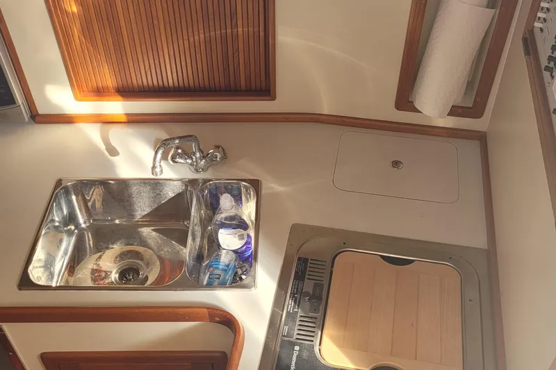 Slide: The Image of Fortier 30 boat kitchen sink and stove area, 2015 model, with sunlight reflections. - 33