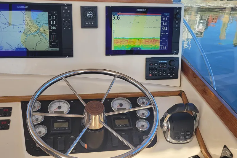Slide: The Image of Boat dashboard with navigation screens and controls, Fortier 30, 2015 model. - 34