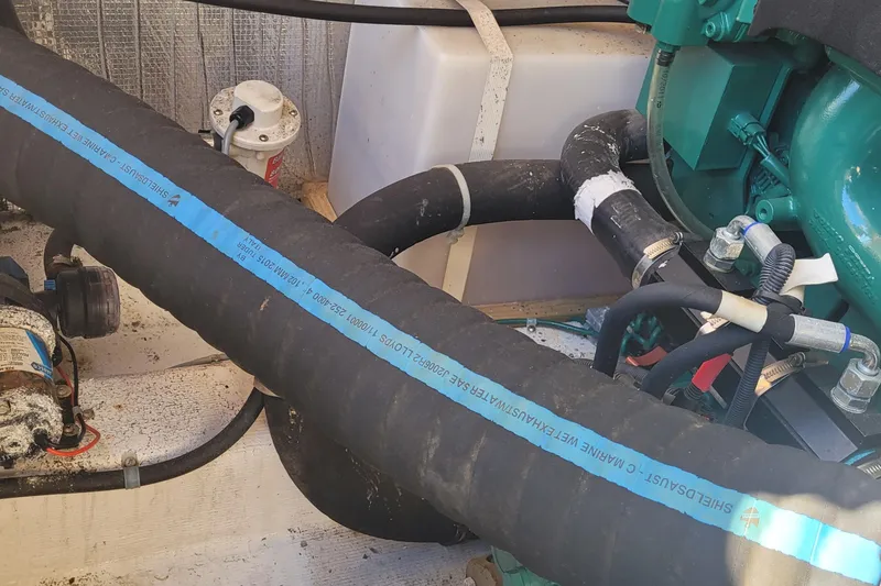 Slide: The Image of Engine compartment of a 2015 Fortier 30 boat with hoses and components. - 41