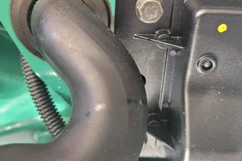 Slide: The Image of Close-up of Fortier 30 engine component, 2015 model, showing a black hose and bolt. - 48