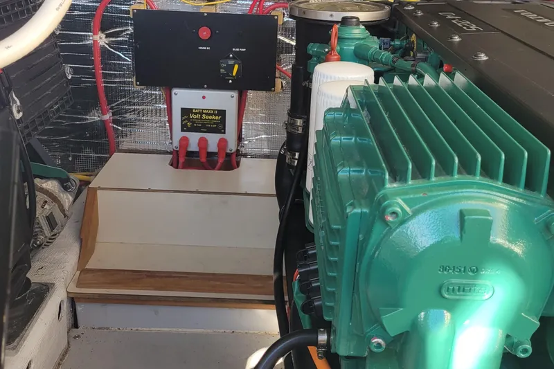 Slide: The Image of Engine room of a 2015 Fortier 30 boat with electrical components and wiring. - 51