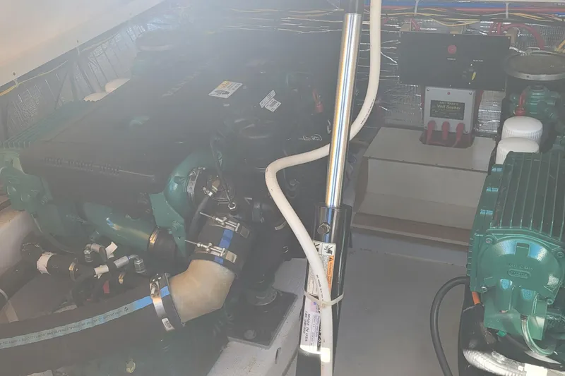 Slide: The Image of Engine compartment of a 2015 Fortier 30 boat, showcasing mechanical components and wiring. - 52