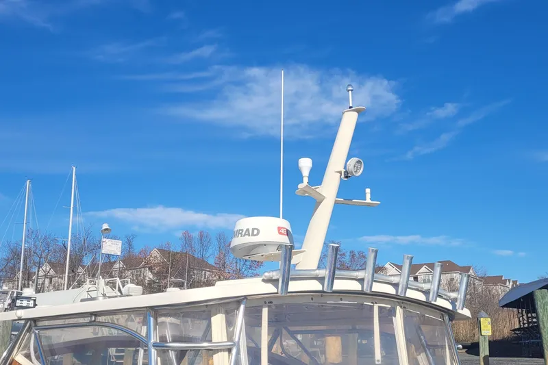 Slide: The Image of 2015 Fortier 30 boat with radar equipment against a clear blue sky. - 62
