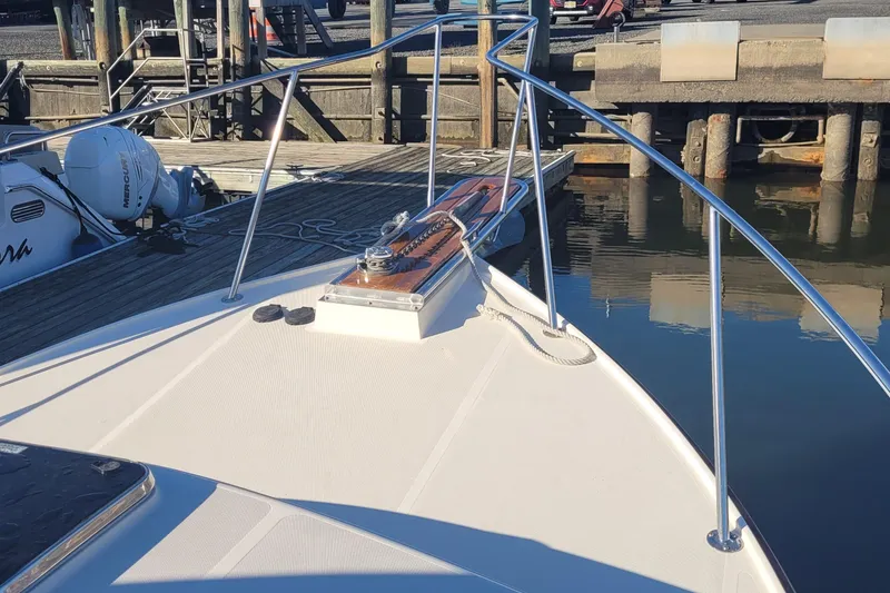 Slide: The Image of Bow of a 2015 Fortier 30 boat docked at a marina. - 7