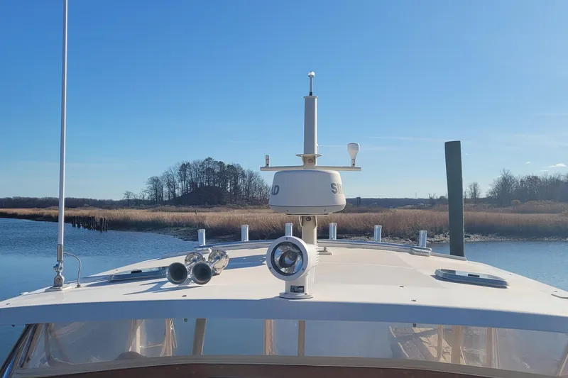 Slide: The Image of Bow of a 2015 Fortier 30 boat docked at a marina. - 10