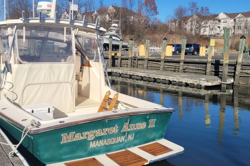 Slide: The Image of 2015 Fortier 30 boat docked on a sunny day by the water. - 3