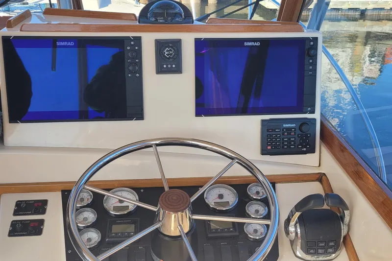 Slide: The Image of Control panel of a 2015 Fortier 30 boat with Simrad navigation system. - 38