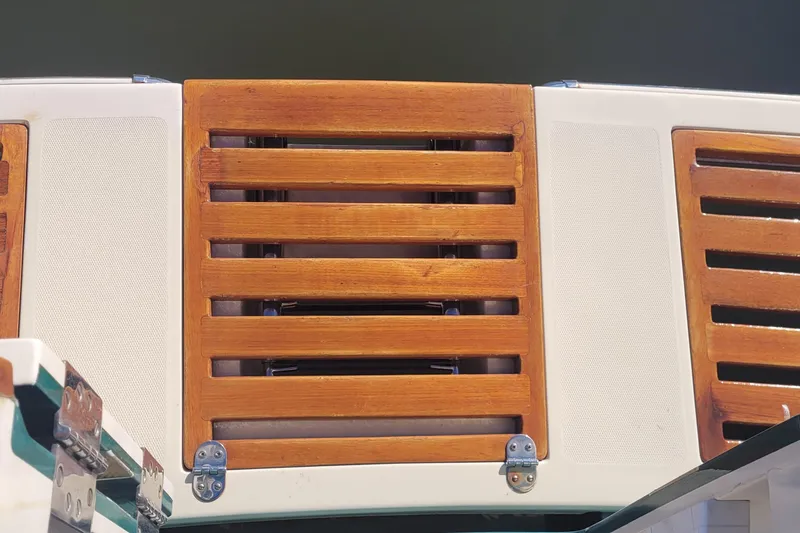 Slide: The Image of Storage compartment on 2015 Fortier 30 boat with orange bucket and metal tools. - 60