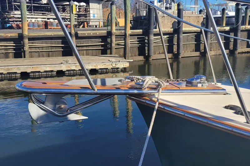 Slide: The Image of Bow of a 2015 Fortier 30 boat docked at a marina. - 63