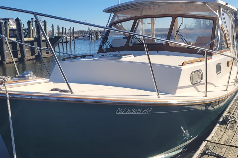 Slide: The Image of 2015 Fortier 30 boat docked at marina, showcasing sleek design and polished finish. - 8