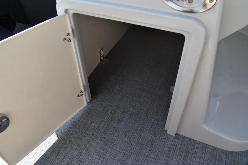 Slide: The Image of Open storage compartment on 2026 Lowe SF 232 Sport Fish boat, featuring gray flooring. - 26