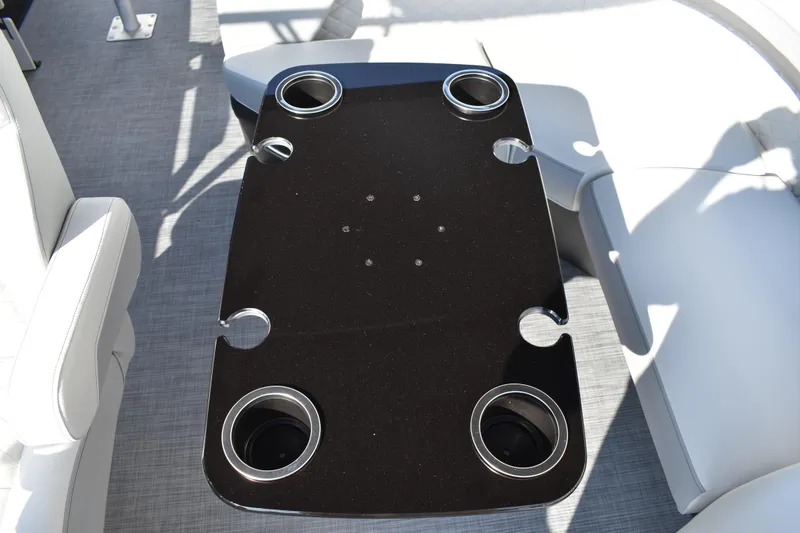 Slide: The Image of 2026 Lowe SF 232 Sport Fish boat interior with sleek black table and cup holders. - 34