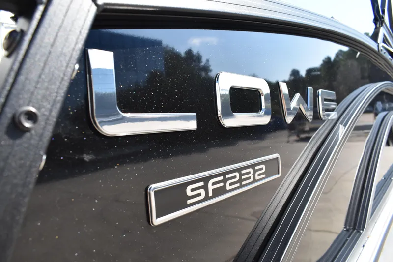 Slide: The Image of 2026 Lowe SF 232 Sport Fish boat logo on sleek black surface. - 4