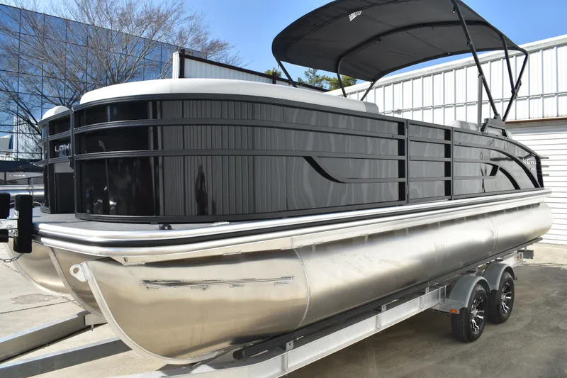 Slide: The Image of 2026 Lowe SF 232 Sport Fish pontoon boat on trailer, sleek black design. - 8