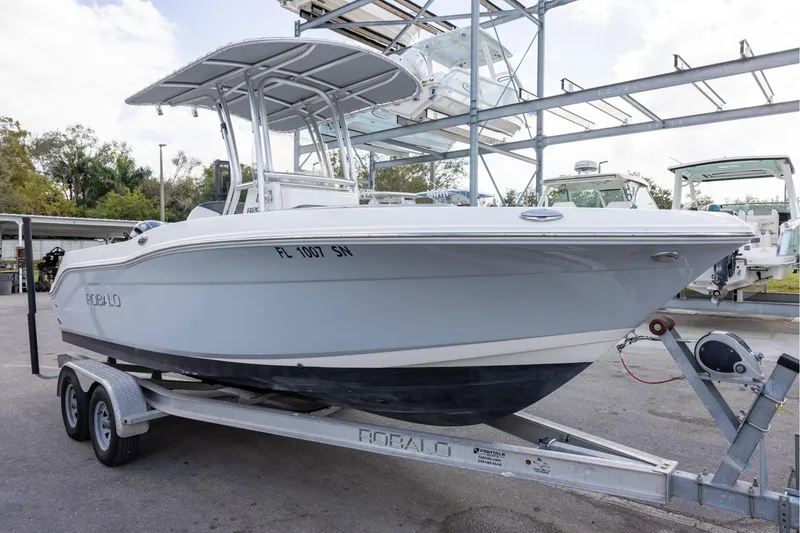 Slide: The Image of 2019 Robalo R202 Explorer boat on trailer, parked outdoors. - 2