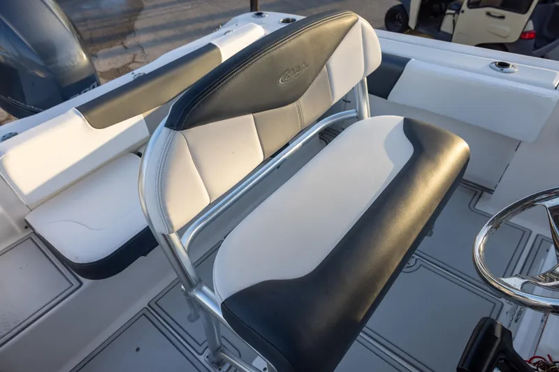 Slide: The Image of 2019 Robalo R202 Explorer boat interior with black and white seating and steering wheel. - 8