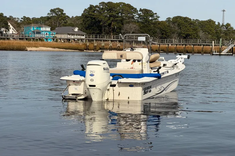 Slide: The Image of 2017 Carolina Skiff 18 JVX CC boat on calm water near shoreline. - 5