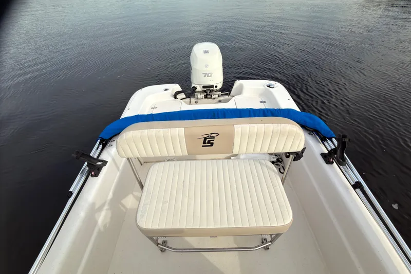 Slide: The Image of 2017 Carolina Skiff 18 JVX CC boat with seating and outboard motor on calm water. - 7