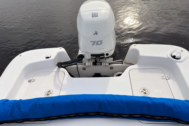 Slide: The Image of 2017 Carolina Skiff 18 JVX CC boat with 70 HP outboard motor on calm water. - 9